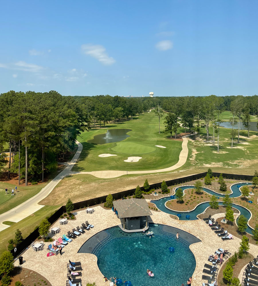 View of Sheraton Hotel in Flowood with a golf course, pool, and lazy river.